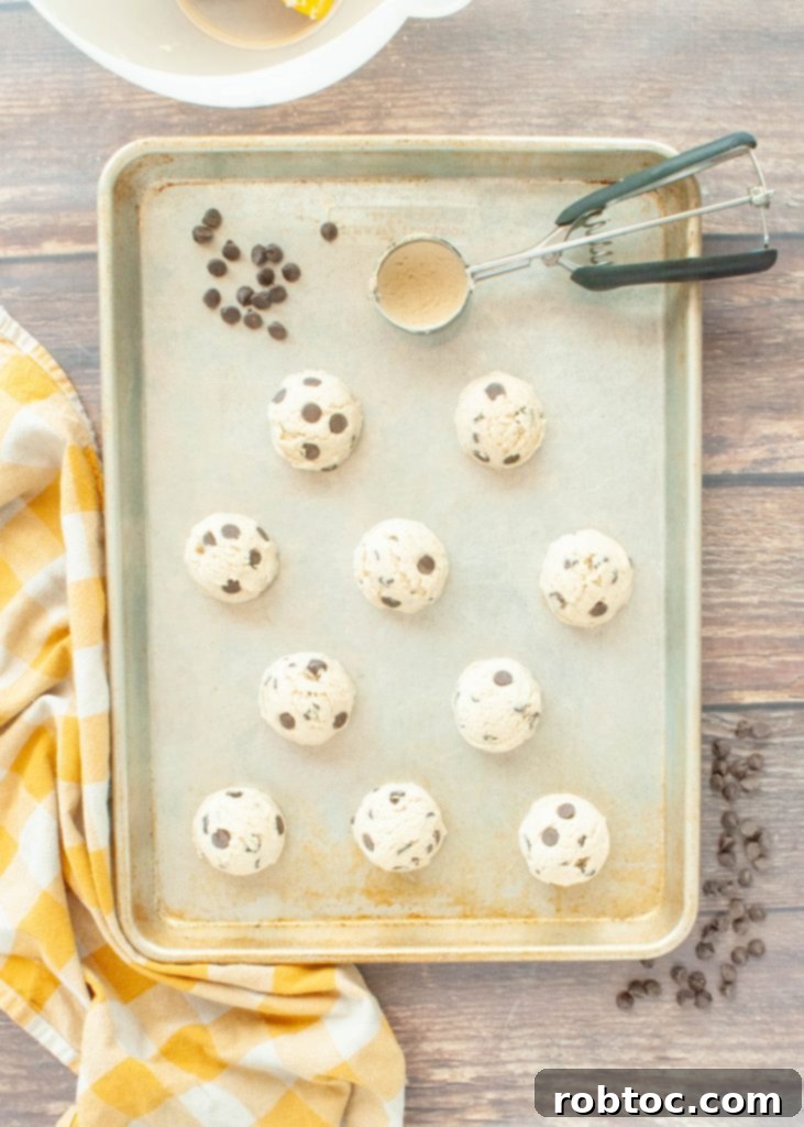 Easy Gluten Free Egg Free Edible Cookie Dough Recipe 7 ball-of-raw-chocolate-chip-cookie-dough-on-a-cookie-sheet