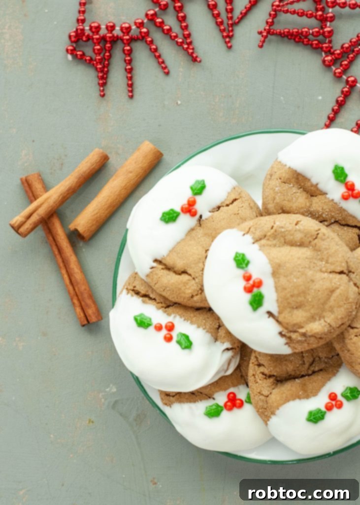gluten-free-gingerbread-cookies-dipped-in-white-chocolate-stacked-on-a-plate