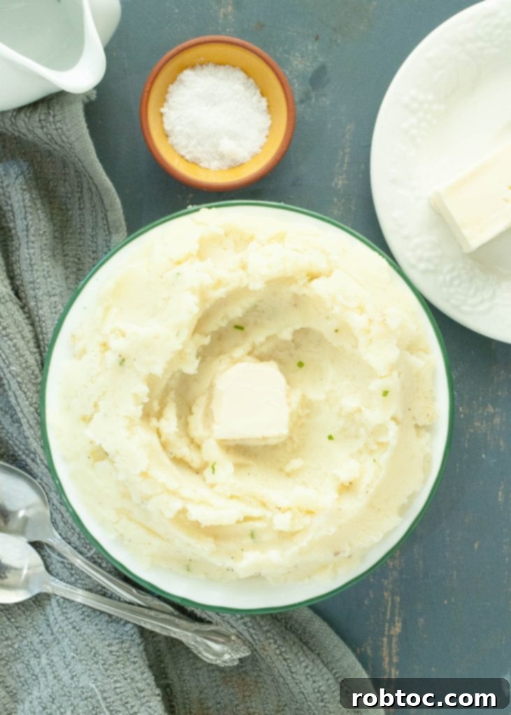 Creamy Dairy-Free Mashed Potatoes Secret Ingredient Video 4 dairy-free-mashed-potatoes-in-a-round-bowl-with-melting-butter-in-the-middle