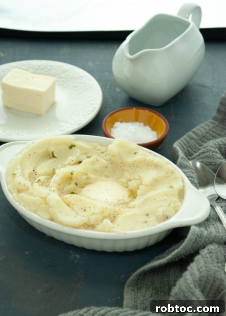 Creamy Dairy-Free Mashed Potatoes Secret Ingredient Video 5 dairy-free-mashed-potatoes-with-gravy-salt-and-butter-next-to-it