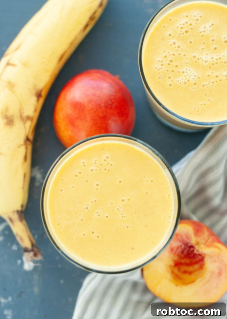 Two cups of whey-free peach protein shake, photographed from above with a vibrant and inviting appearance.
