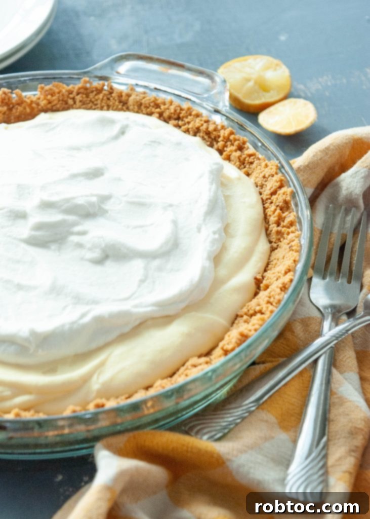Stunning close-up of a gluten-free dairy-free lemon cream pie, showcasing the vibrant lemon filling and whipped topping.